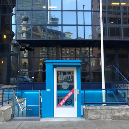 Vibrant blue external to internal access lift for gym goers
